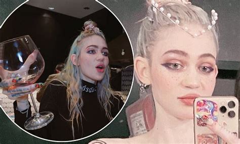 Grimes poses topless as she shows off her body art design